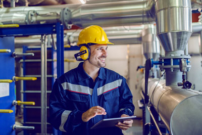 Smiling Worker in Industrial Setting